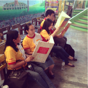 (DHL Volunteers prepare for a storytelling activity at Holy Spirit Elementary School last February 28, 2014)